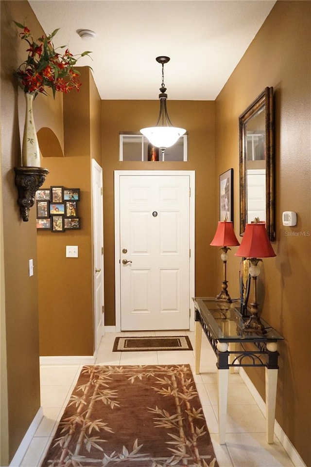 doorway to outside with light tile patterned floors