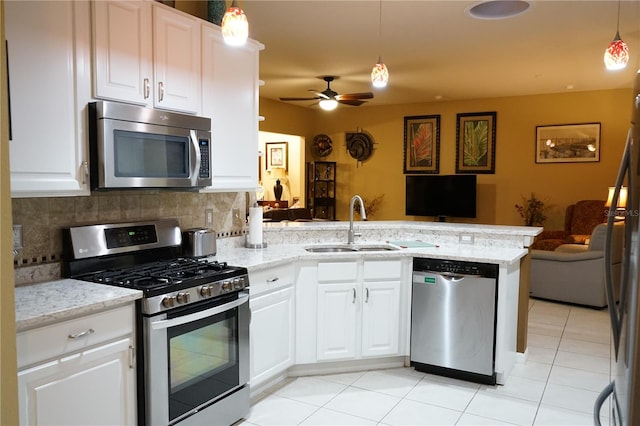 kitchen featuring white cabinetry, sink, kitchen peninsula, and appliances with stainless steel finishes