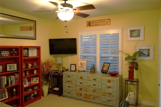 interior space with ceiling fan