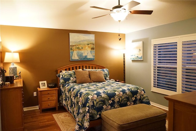 bedroom with dark hardwood / wood-style floors and ceiling fan