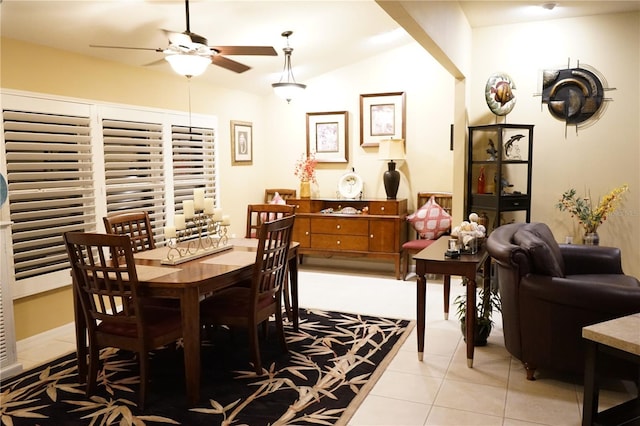 tiled dining space featuring vaulted ceiling and ceiling fan