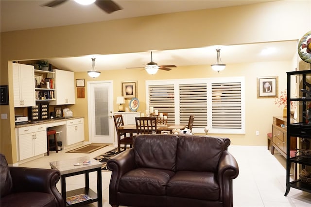 tiled living room featuring ceiling fan