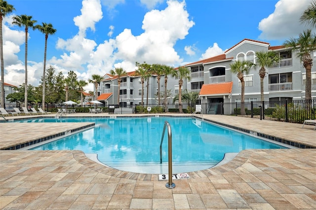 pool featuring a patio area and fence