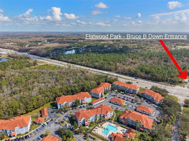 bird's eye view with a water view and a view of trees