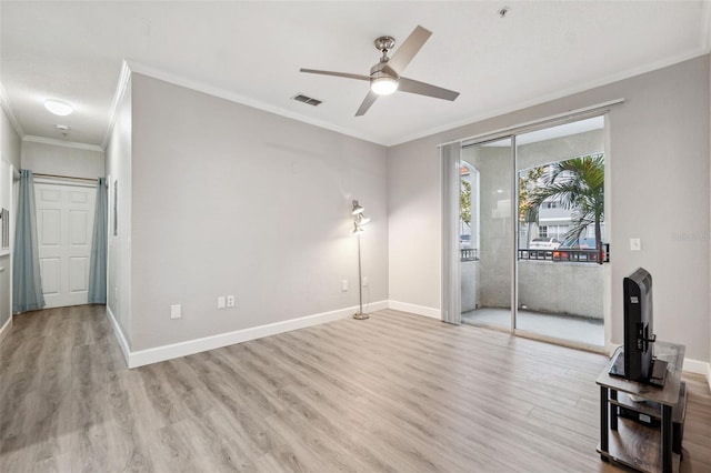 unfurnished living room with light wood finished floors, visible vents, baseboards, ceiling fan, and crown molding