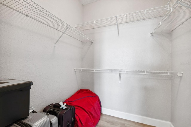 spacious closet with wood finished floors