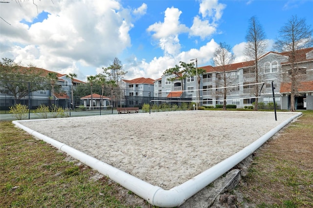 surrounding community featuring a residential view, fence, and volleyball court