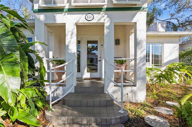 property entrance with stucco siding