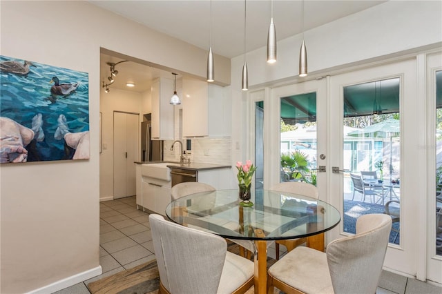 dining room with light tile patterned floors, french doors, and baseboards