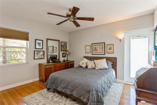 bedroom with wood-type flooring, ceiling fan, and baseboards