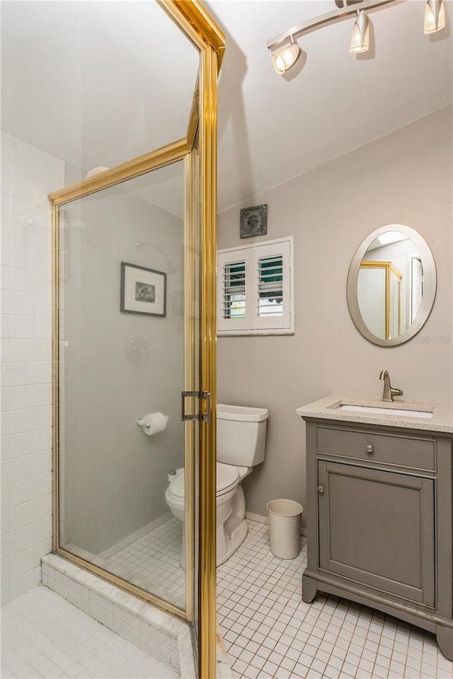 full bath with vanity, a shower stall, toilet, and tile patterned floors