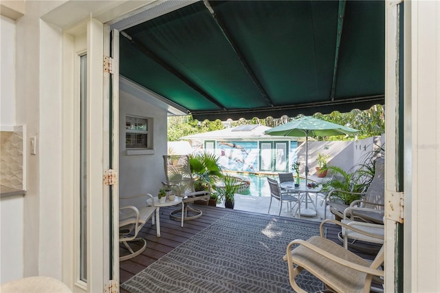 balcony with outdoor dining area and a sunroom