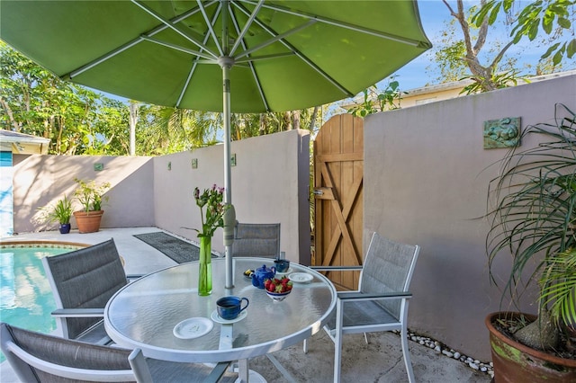 view of patio / terrace with a fenced backyard, a fenced in pool, and outdoor dining space