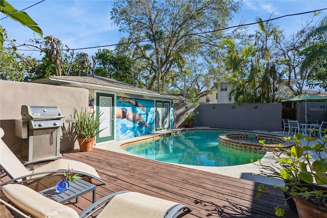 view of pool featuring area for grilling, a wooden deck, a pool with connected hot tub, and fence