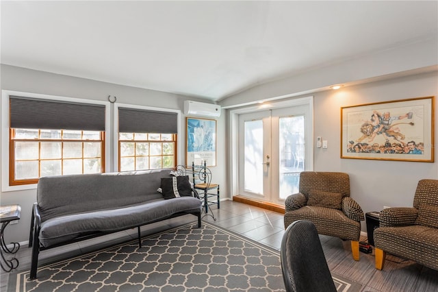 living room featuring a wall unit AC, baseboards, a wealth of natural light, and lofted ceiling