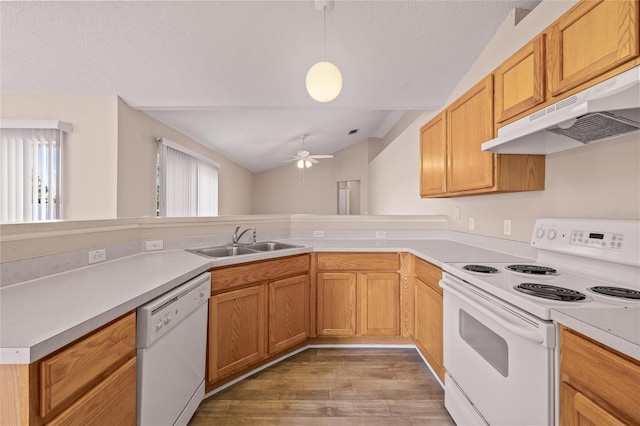 kitchen with lofted ceiling, sink, white appliances, decorative light fixtures, and ceiling fan