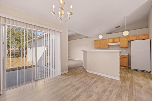 kitchen with an inviting chandelier, decorative light fixtures, light hardwood / wood-style flooring, and white fridge