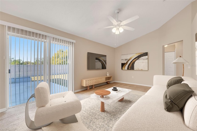 carpeted living room with vaulted ceiling and ceiling fan