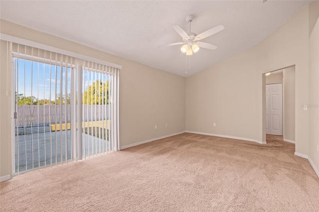 carpeted empty room featuring ceiling fan, lofted ceiling, and a textured ceiling