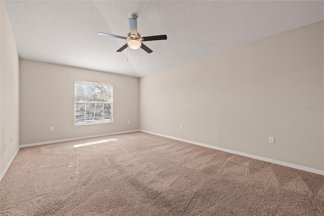 carpeted empty room featuring ceiling fan and a textured ceiling