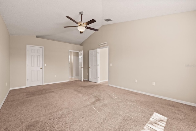 unfurnished bedroom featuring vaulted ceiling, carpet, a textured ceiling, and ceiling fan