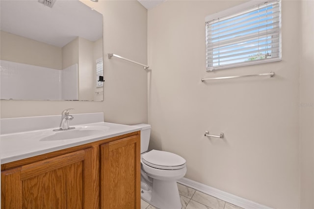 bathroom featuring vanity, tile patterned floors, and toilet