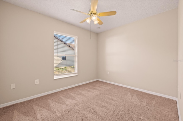 spare room featuring a textured ceiling, ceiling fan, and carpet