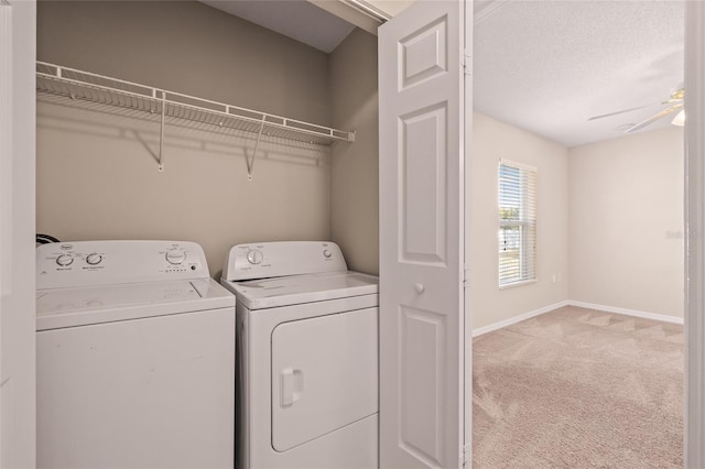 washroom featuring light carpet, ceiling fan, a textured ceiling, and washing machine and clothes dryer