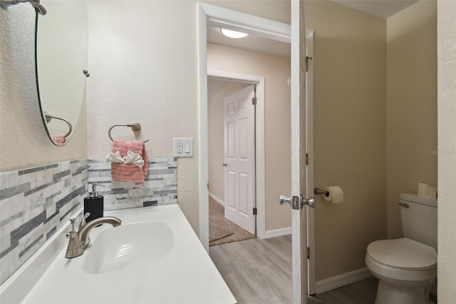 bathroom with vanity, hardwood / wood-style floors, and toilet