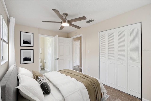 bedroom featuring connected bathroom, a closet, ceiling fan, and carpet flooring