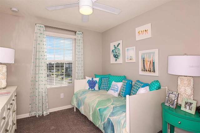 bedroom featuring ceiling fan and dark carpet