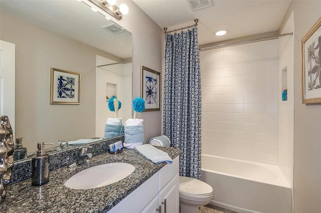 full bathroom featuring toilet, vanity, shower / bathtub combination with curtain, and a textured ceiling