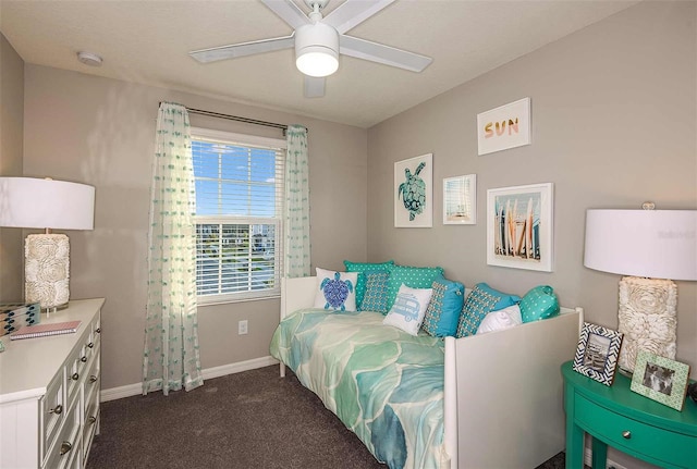 bedroom featuring ceiling fan and dark carpet