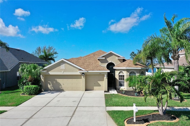 view of front of house featuring a garage and a front yard