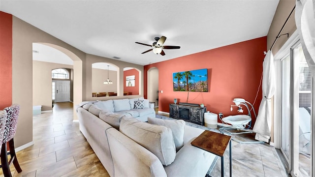 living room with light tile patterned flooring and ceiling fan