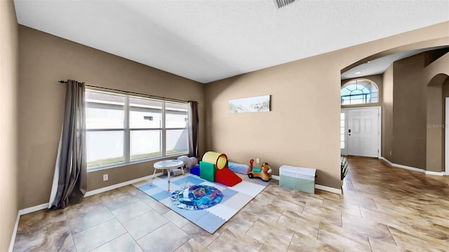 recreation room with light tile patterned floors