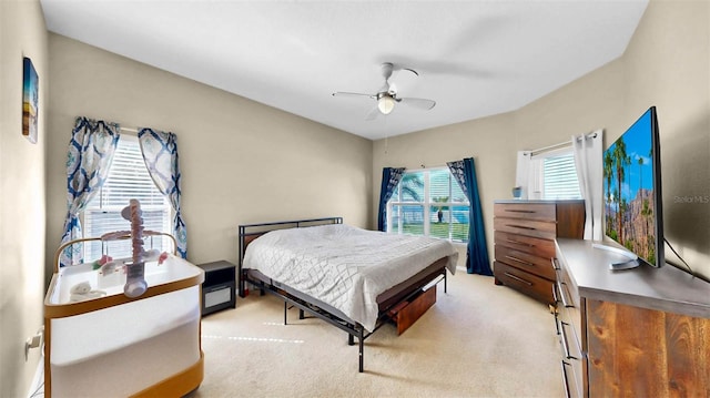 bedroom with light colored carpet and ceiling fan