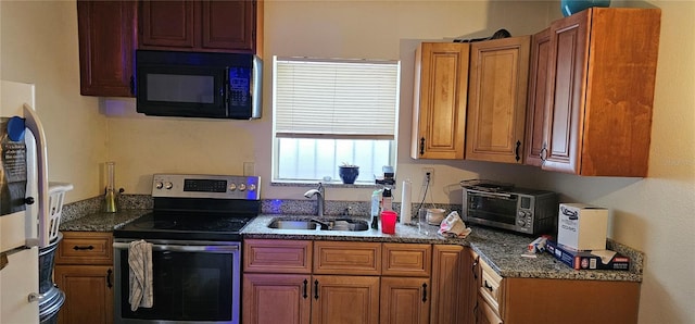 kitchen featuring stainless steel range with electric stovetop, sink, dark stone countertops, and white refrigerator