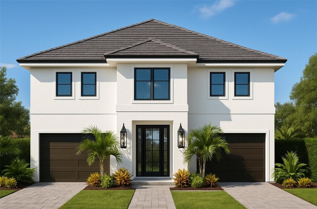 view of front of property with an attached garage, a tiled roof, stucco siding, and driveway