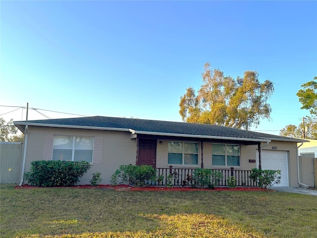 single story home featuring a porch, a garage, and a front lawn