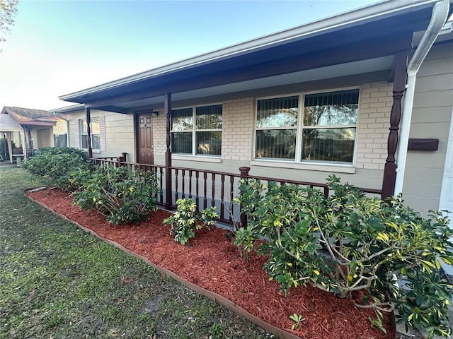 view of side of home with covered porch