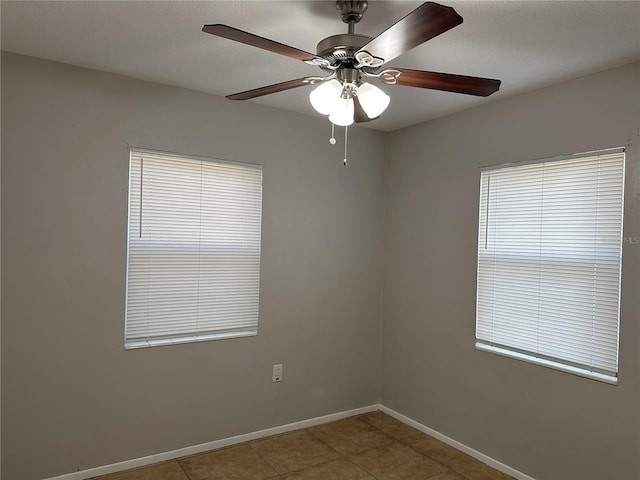 tiled empty room with ceiling fan and a textured ceiling