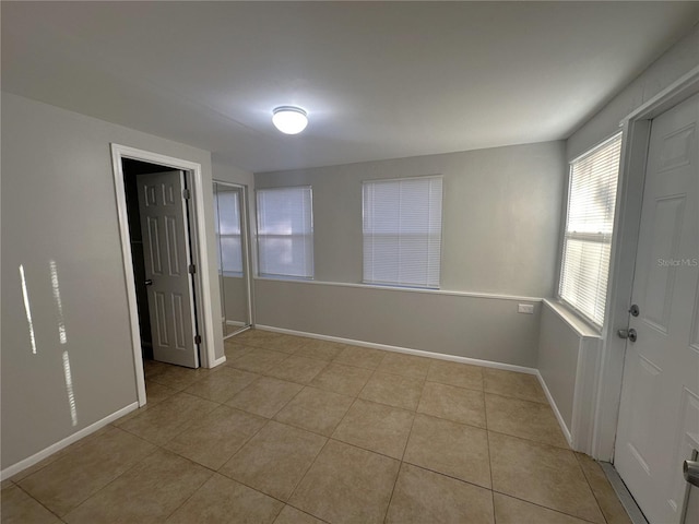 empty room with light tile patterned flooring