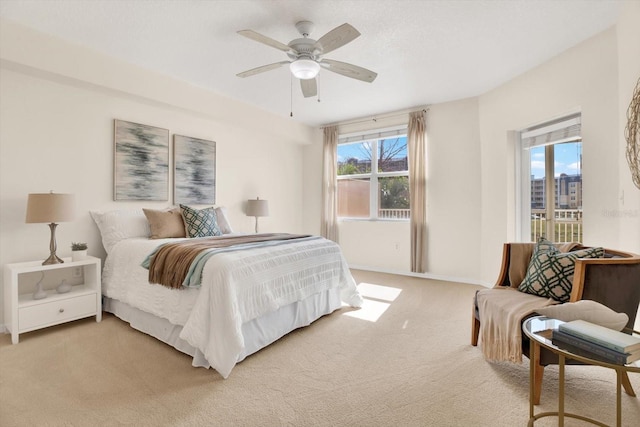 bedroom with carpet floors, access to exterior, and ceiling fan