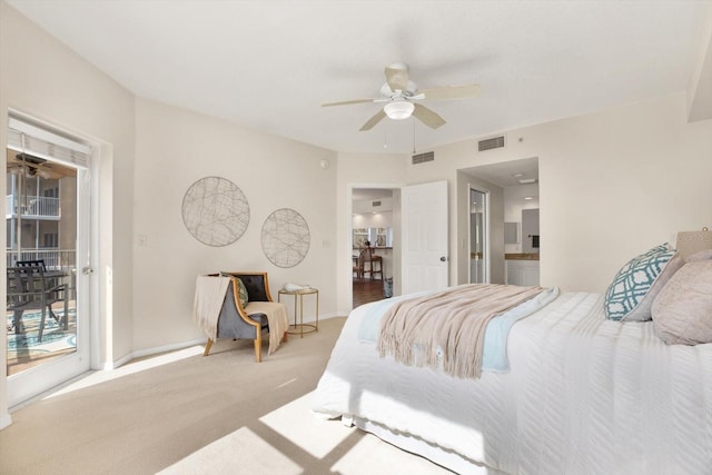 bedroom featuring ensuite bathroom, access to outside, light carpet, and ceiling fan