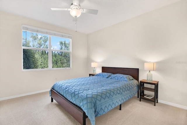 bedroom featuring ceiling fan and light carpet