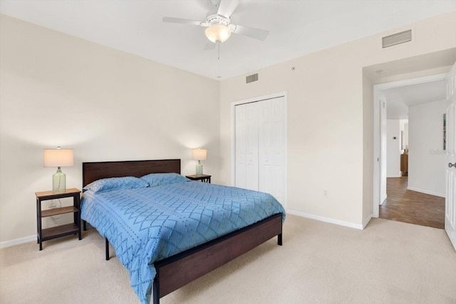 carpeted bedroom featuring ceiling fan and a closet