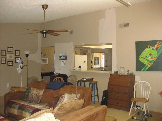 living room with ceiling fan and high vaulted ceiling