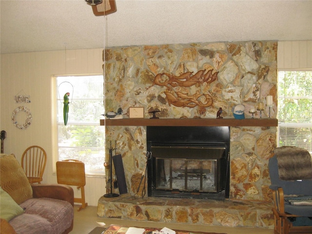 interior space with a stone fireplace and a textured ceiling