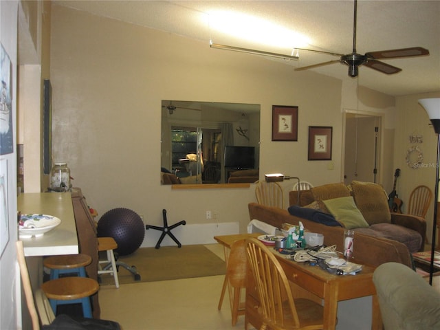 dining room with ceiling fan and vaulted ceiling